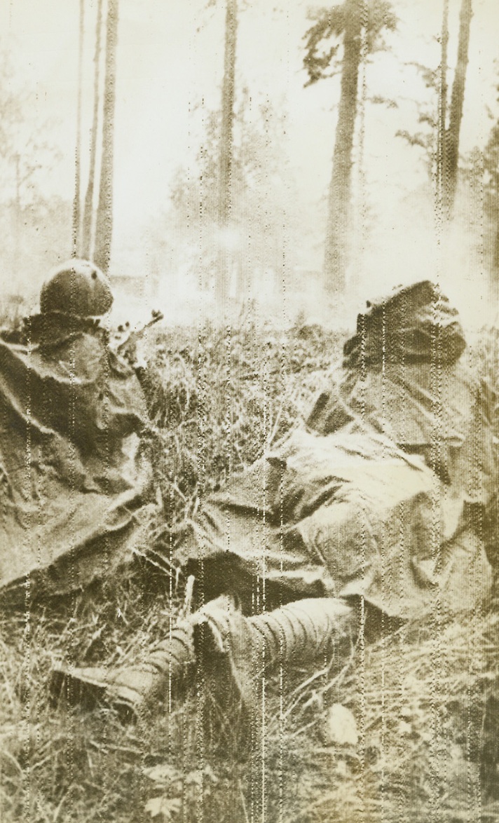 Red Army in Finnish Drive, 6/14/1944. Karelian Isthmus—The Red Army, storming its way into Finland, continues to advance along the narrow Karelian front. Crack Finnish units, fighting stubbornly behind formidable fortifications, have slowed its progress slightly. Yesterday the Soviets reported a gain of six miles. Camouflages Soviet infantrymen fire from a wooded area as they dislodge Finnish tommygunners from houses on the outskirts of Terrioki. Credit: ACME radiophoto.;