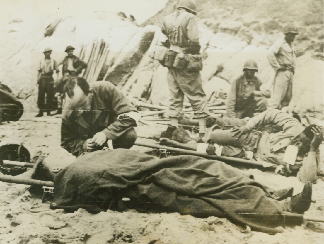 The Price Of Battle, 6/20/1944. Washington – A French Chaplain administers last rites to a wounded French soldier on the beach at Elba, during the conquest of the famous island. French soldiers were among the first to feel the effects of war. At first defeated, they were reorganized, then thrown back into battle as an important unit of the Mediterranean Forces. Now they again feel war’s sting and pay the price of battle. 6/20/44 Credit (Signal Corps Radio-Telephoto From Algeria Via ACME);