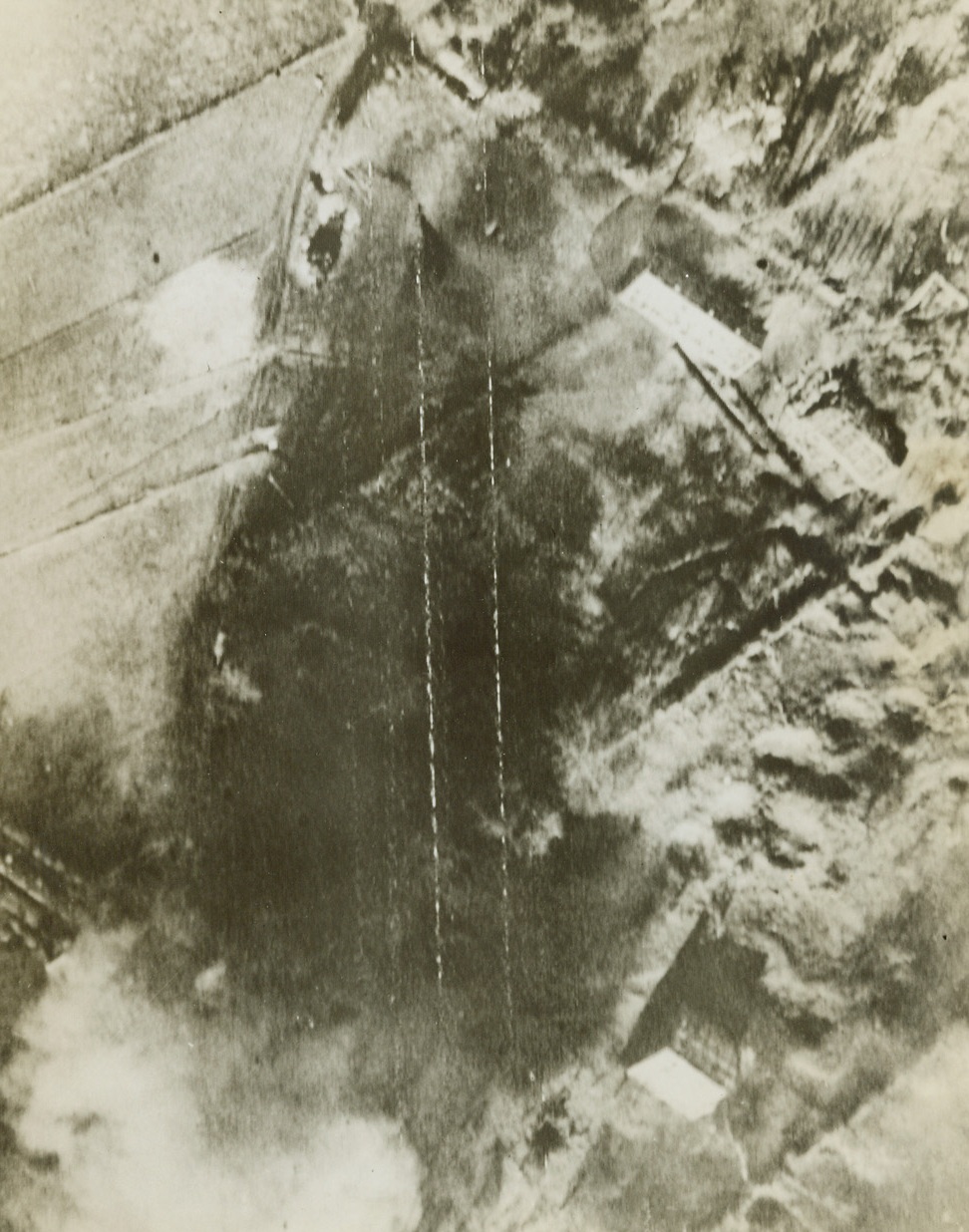 Hit ‘em Where It Hurts, 6/21/1944. Northern France -- Flying bomb installations in Northern France, the launching site with ramp (bottom center) and the auxiliary buildings, are blasted by an attack by the RAF. Credit: British Air Ministry photo from ACME;