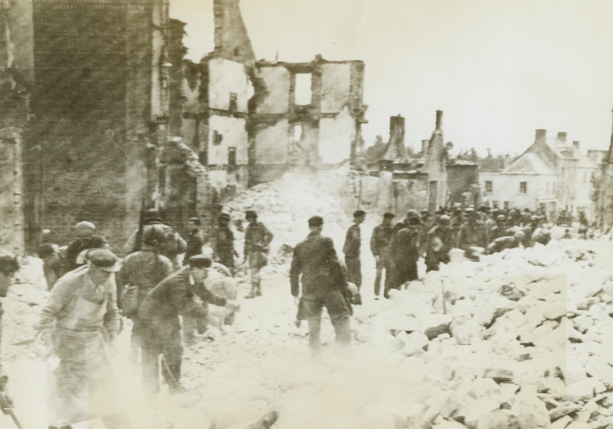 Montebourg Street Scene, 6/22/1944. France -- French civilians and American troops work side by side to clear the streets of Montebourg, France, from rubble left by the bitter battle between the Allies and the Nazis for the strategic town. Terrific American bombardment preceeded occupation of the city. Credit: Army photo from ACME;