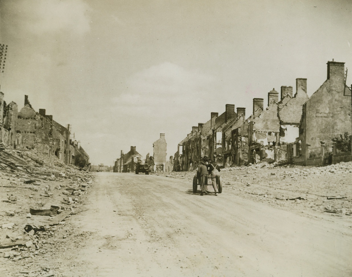 Marked By War, 6/22/1944. France - Gutted homes line the road out of Pont L`Abbe as these inhabitants of the city leave for a safer area. Nazis put up stiff resistance before the Allied Armies of Liberation forced them into retreat from this stronghold. Credit: ACME;