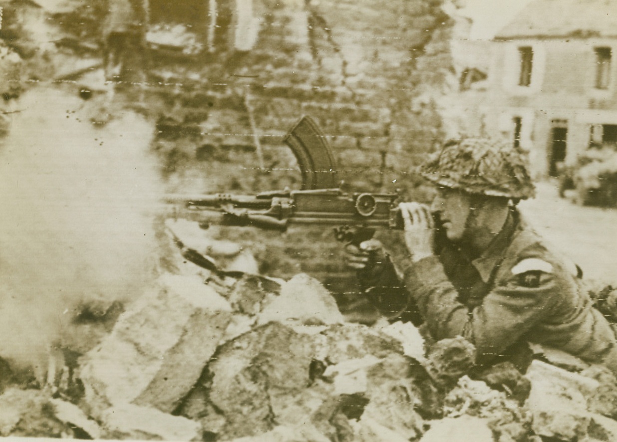 Quick Death For Nazi Snipers, 6/14/1944. France - A British Bren Gunner fires a burst at some of the enemy Rearguard, left behind in Bayeux before it was captured by the Allies. Today, despite five separate Nazi counter-attacks along the French Front, British, American and Canadian troops are holding fast. Credit: British Official photo via Army Radiotelephoto from ACME;