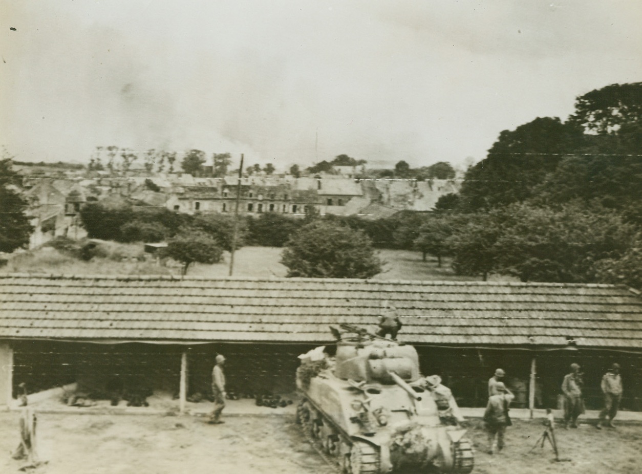 Victory Ahead, 6/27/1944. Cherbourg, France – This is the scene which met the eyes of the Yanks a few minutes before Cherbourg fell into their hands. The key port, their goal during the entire drive up the Normandy Peninsula, lies just ahead, under a pall of battle smoke. When the end loomed near, the Nazis demolished almost everything in sight, especially in the section around the docks, where they took their last stand. Credit: Army photo from ACME;