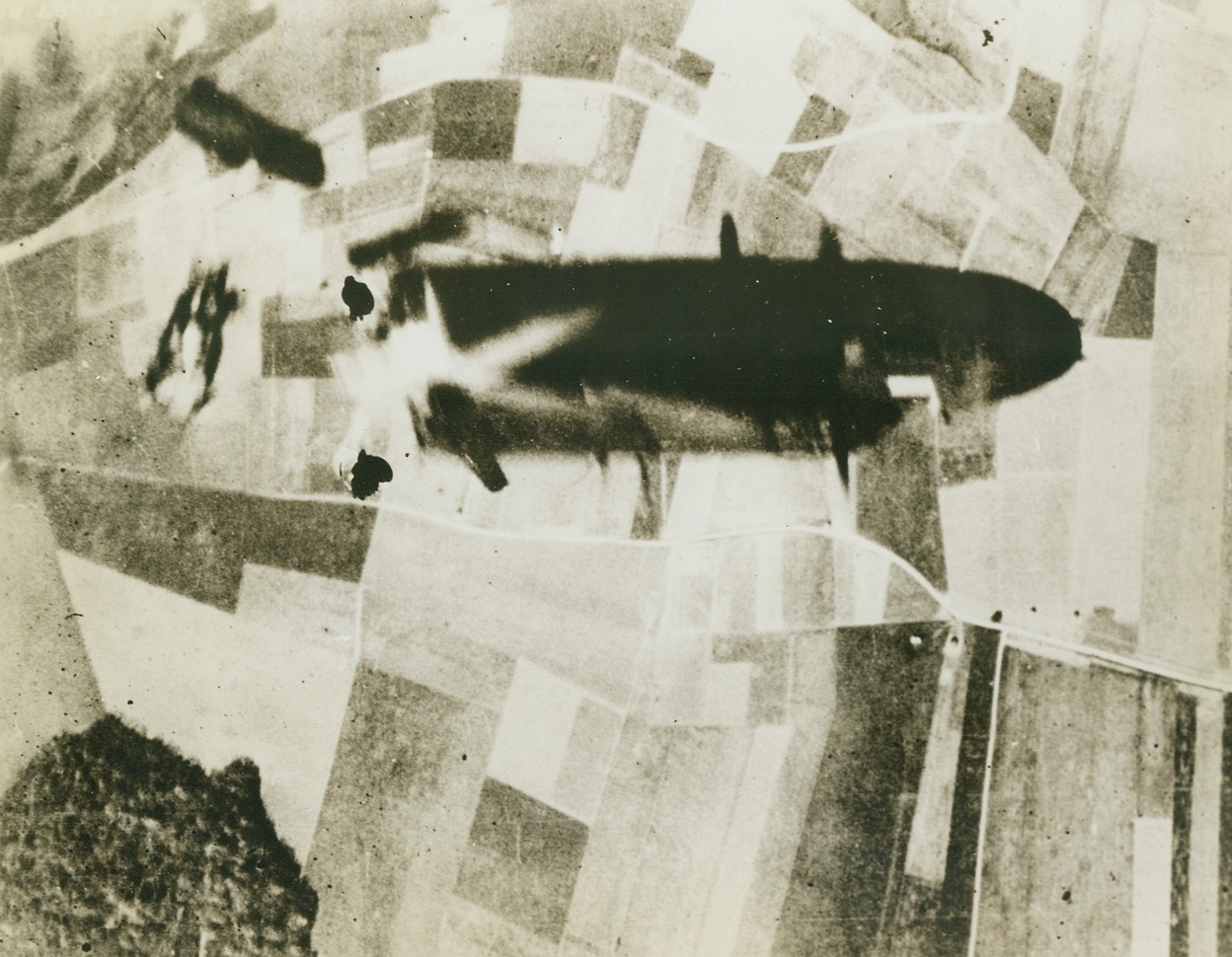 Death on the Wing, 6/29/1944. France – A B-26 Marauder, hit by flak over the French coast, literally is blown to bits, with only the nose of the once magnificent ship momentarily aloft. Remarkable photo was taken by accompanying plane’s camera. Credit: USAAF photo from ACME; France – A B-26 Marauder, hit by flak over the French coast, literally is blown to bits, with only the nose of the once magnificent ship momentarily aloft. Remarkable photo was taken by accompanying plane’s camera. Credit: USAAF photo from ACME;