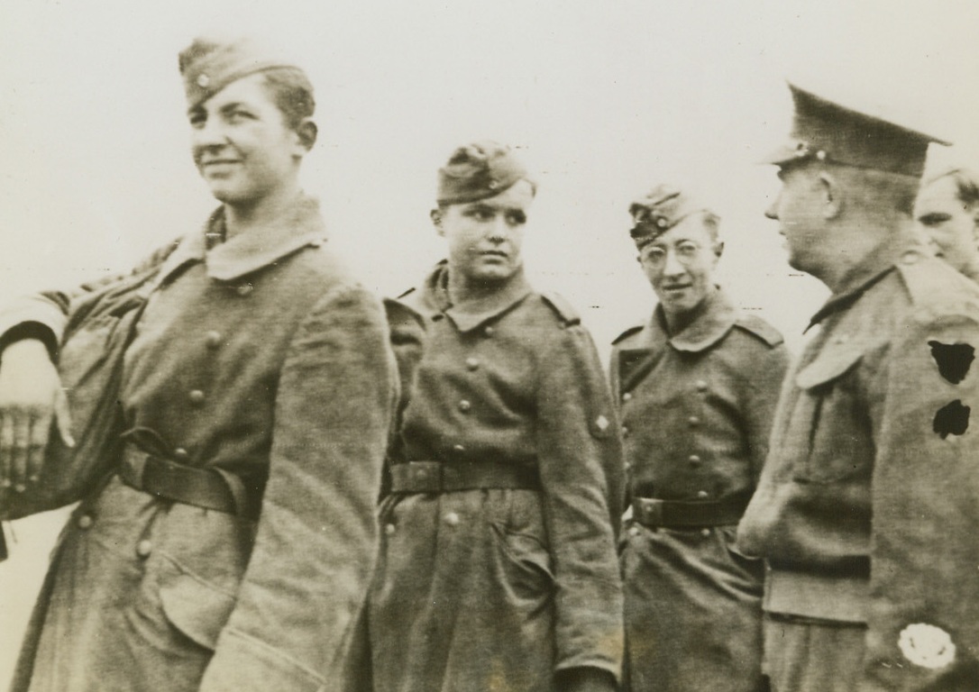 Youthful Nazis Captured In France, 6/9/1944. England – Regulars of Hitler’s West Wall Army, these youthful prisoners of war smile and seem rather happy that the war is over for them. They are lined up waiting entrance into prisoner of war compounds. Credit: Signal Corps Radiotelephoto from ACME;