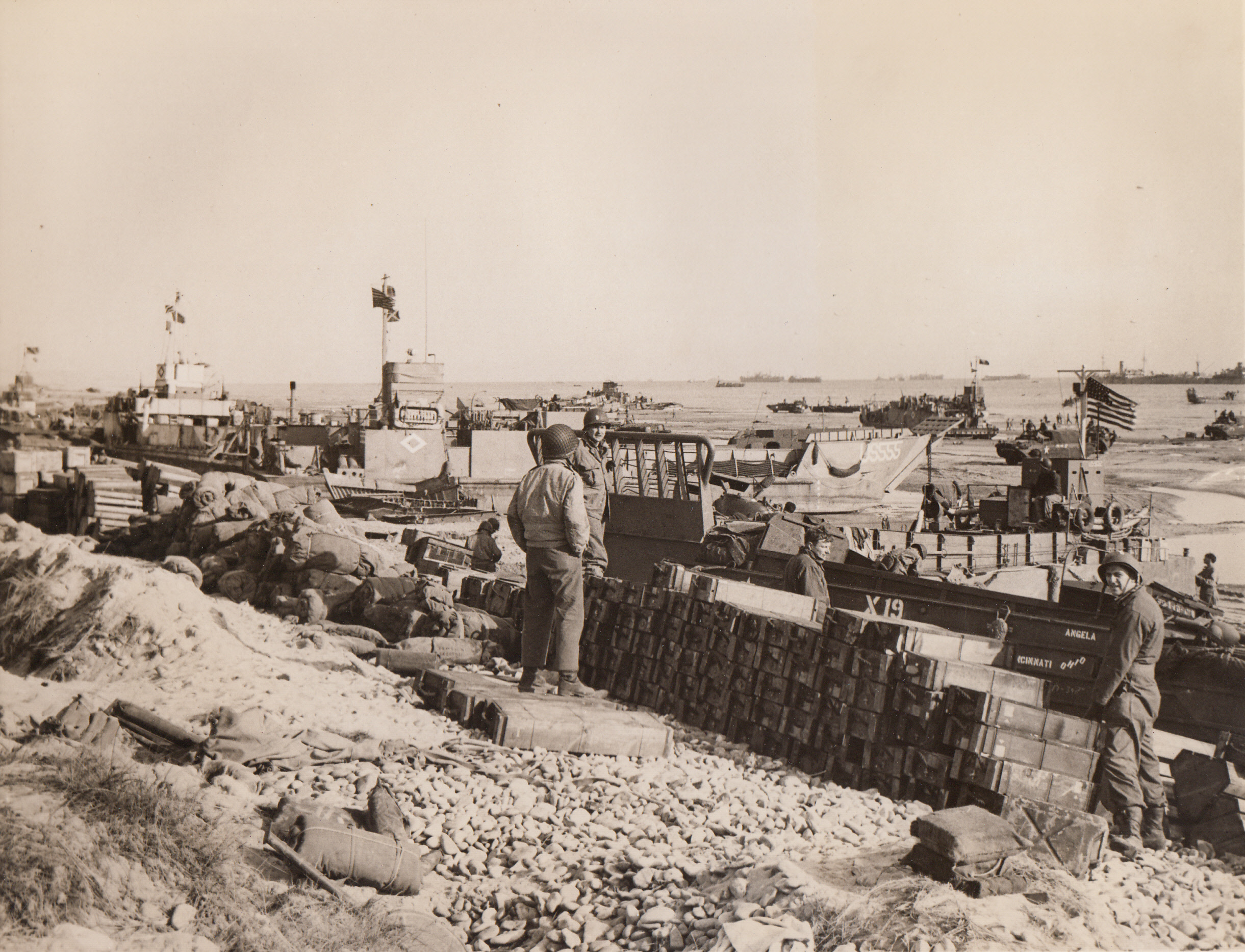 Supplies, Supplies, Supplies, 6/15/1944. France – There’s scarcely an inch of beachhead space that doesn’t hold some sort of equipment for fighting men, as the endless chain of supplies streams across the Channel to our soldiers in France. Fighting men check the vast amount of food and weapons dumped on this Normandy beach.;