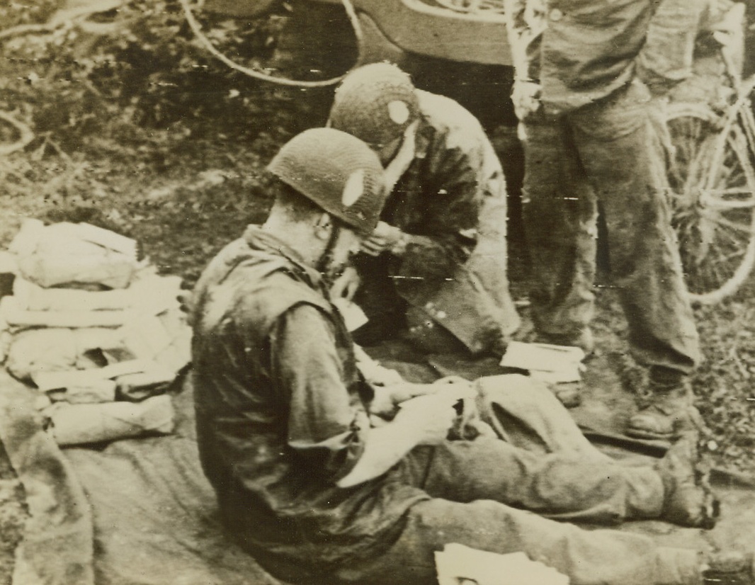 Fighter’s Reward, 6/15/1944. France – These Allied soldiers along the “liberation beachhead” receive their first mail from home since landing in France, which they read avidly during a moment’s lull in the fighting. Credit: British War Office photo via Army radiotelephoto from Acme;