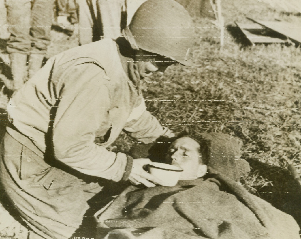 When Water Really Tastes Good, 6/13/1944. France – One of some hundreds of British and American fighting men, wounded in the first stage of the liberation of France, Hailand P. Braley learns how good water can taste at an advanced hospital. Army Nurse Margaret Ketchum, one of the U.S. women who are doing such a wonderful job bringing relief to the wounded, helps him to drink. Credit: Signal Corps Radiotelephoto from ACME;