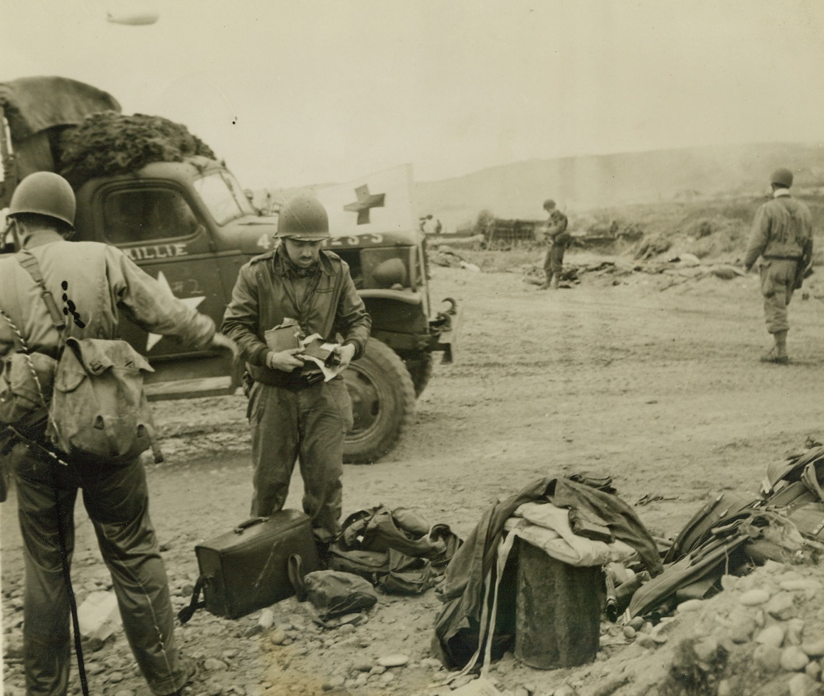 Why Photographers Get Gray!, 6/13/1944. France – Bert Brandt, ACME War Pool photographer, after swimming ashore on the Allied beachhead along the Norman Coast, carefully dries off his equipment. It was a tossup whether his stuff was ruined by the sea water, or not. But it was “not,” for he turned in an outstanding job of covering the invasion action and his photos were the first to reach London—and the U.S.—of any of the pool men. Passed by censors. Credit: ACME photo by Bert Brandt for War Picture Pool;