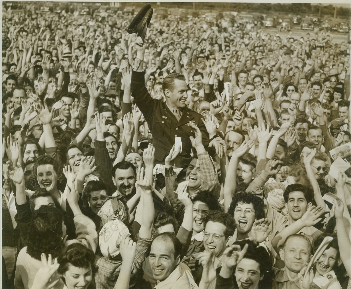 Aircraft Workers Cheer Air Ace, 6/9/1944. FARMINGDALE, L.I. – Clapping and cheering loudly, workers at the Long Island plant of Republic Aviation Corp. lift Maj. Robert S. Johnson to their shoulders in a triumphant parade in recognition of the air ace’s  record of 27 planes downed in the ETO. Maj. Johnson was a guest at the Republic plant, makers of the famous Thunderbolt fighter plane, which he flew in combat. Upon his return to the U.S. the air ace was received at the White House by the President and Mrs. Roosevelt, and was recognized on the floor of the U.S. House and Senate. Credit (ACME);