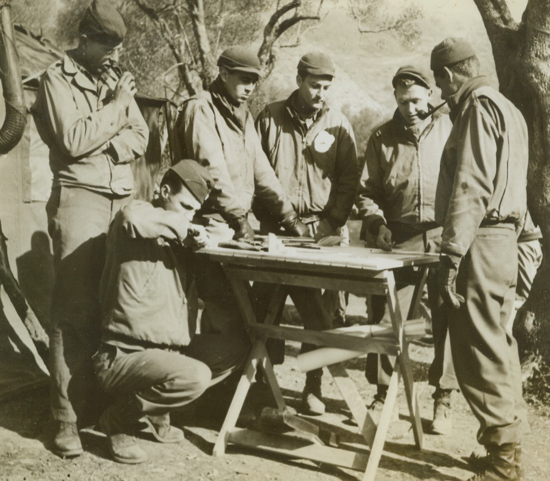 At Fifth Army Planning Table, 7/25/1944. ITALY -- At a field planning table with the Fifth Army in Italy, are (left to right): standing, Lt. Jack Epping, Quincy, Ill.; Lt. R.E. Smith, Callaway, Neb.; Lt. Eugene De Hermida, Sacramento, Calif.; Capt. James Ramsey, Marmaduke, Ark.; and Capt. Alfred H. McCutcheon, of Fort Davis, Texas.  Credit Line (ACME) (WP);