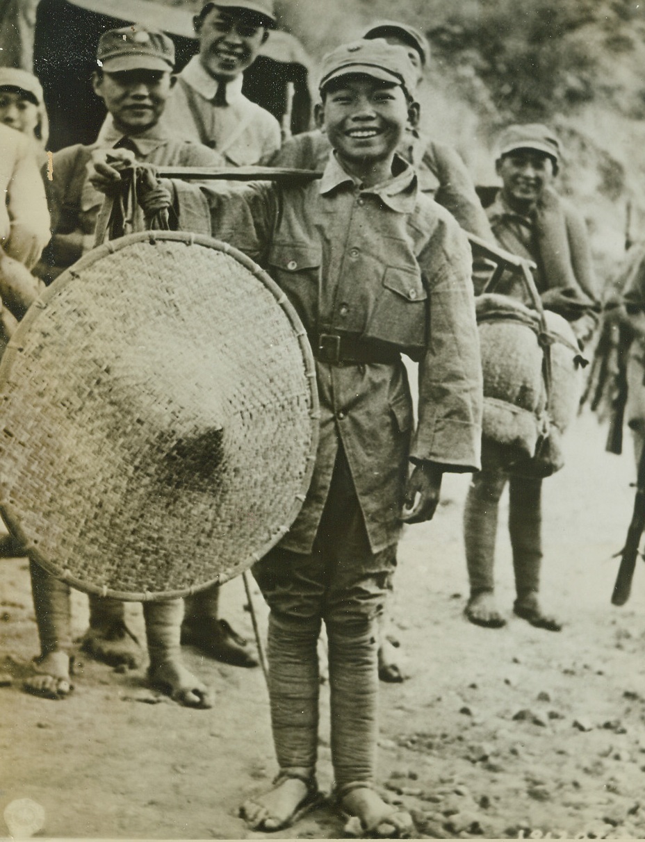 Young Chinese Soldier, 7/15/1944. China – Seven-year-old Pvt. Koo Ho King is graphic proof that youth is no barrier to service in the Chinese Army. Many of the best soldiers in the Chinese Armies are youngsters in their teens. Here Pvt. Koo and some of his fellow soldiers move up supplies in the offensive against the Japs along the Salween River Front.Credit: Signal Corps photo from ACME;