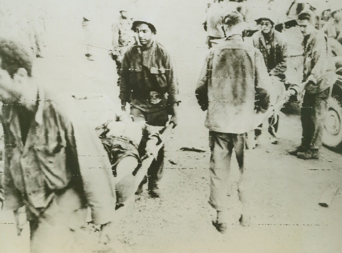 Yank Wounded on Saipan, 7/1/1944. Saipan- - Wounded Americans are brought to a captured Jap shack on Saipan which has been converted to an aid station.  Comrades gently carry the stricken soldiers on stretchers.  In taking half the Jap stronghold in the Marianas, American Marines and infantrymen have suffered 9,752 killed, wounded, and missing in action.Credit (US Army radio telephoto from ACME);