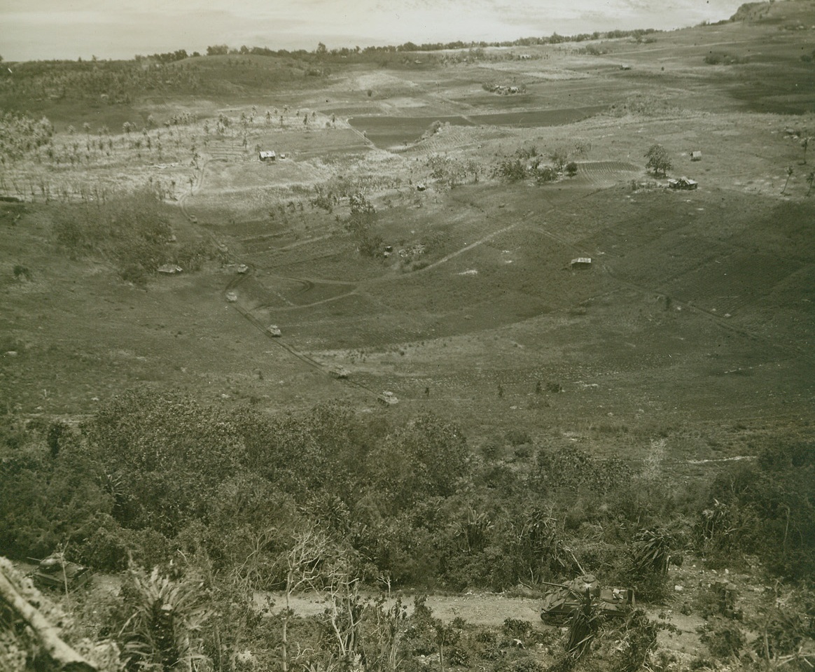 Saipan Panorama, 7/21/1944. Saipan - Second Division Marine tanks move up a hill above Tanapag Harbor in this panoramic view of fighting on Saipan.  The tanks were used to knock out enemy machine gun nests threatening our front line troops.;