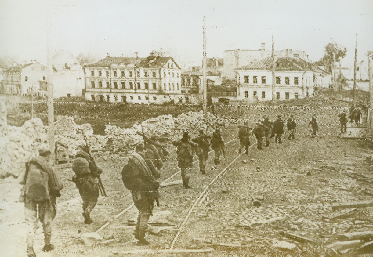 Soviet Infantry on the March, 7/25/1944. PSKOV, POLAND—Soviet infantrymen pass through a street in Pskov after fleeing Germans demolished the town. The Russian Army is now less than 50 miles from Warsaw, the Polish capitol. Credit: ACME Radiophoto;
