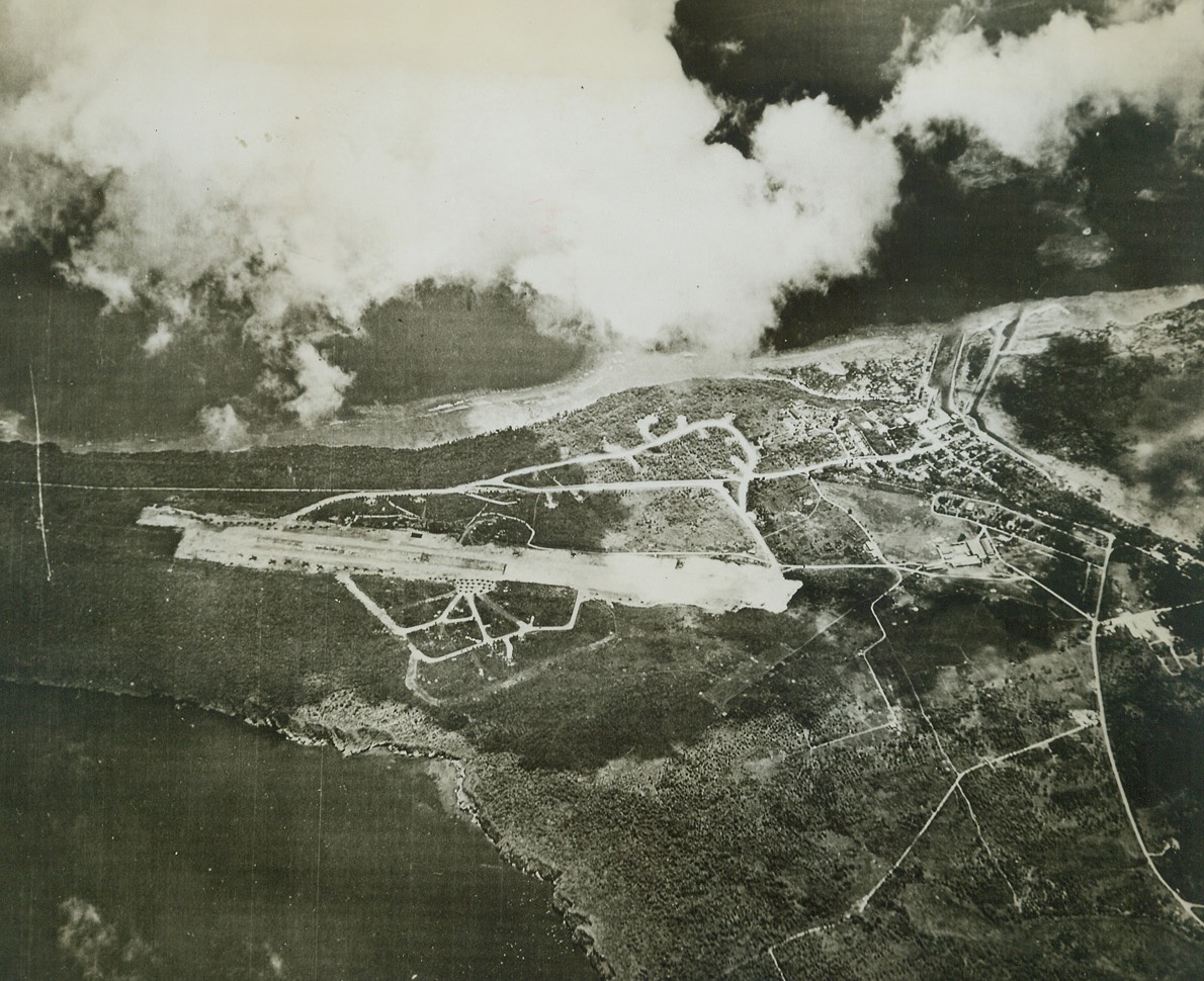 Objective in Guam Attack, 7/21/1944. Guam Is. – This Jap airfield on Guam, pictured from a Navy reconnaissance plane, is one of the objectives toward which Marine and Army troops are pressing after the invasion of July 20.  Guam is only 579 miles Southeast of Tokyo. Credit (US Navy official photo from ACME);