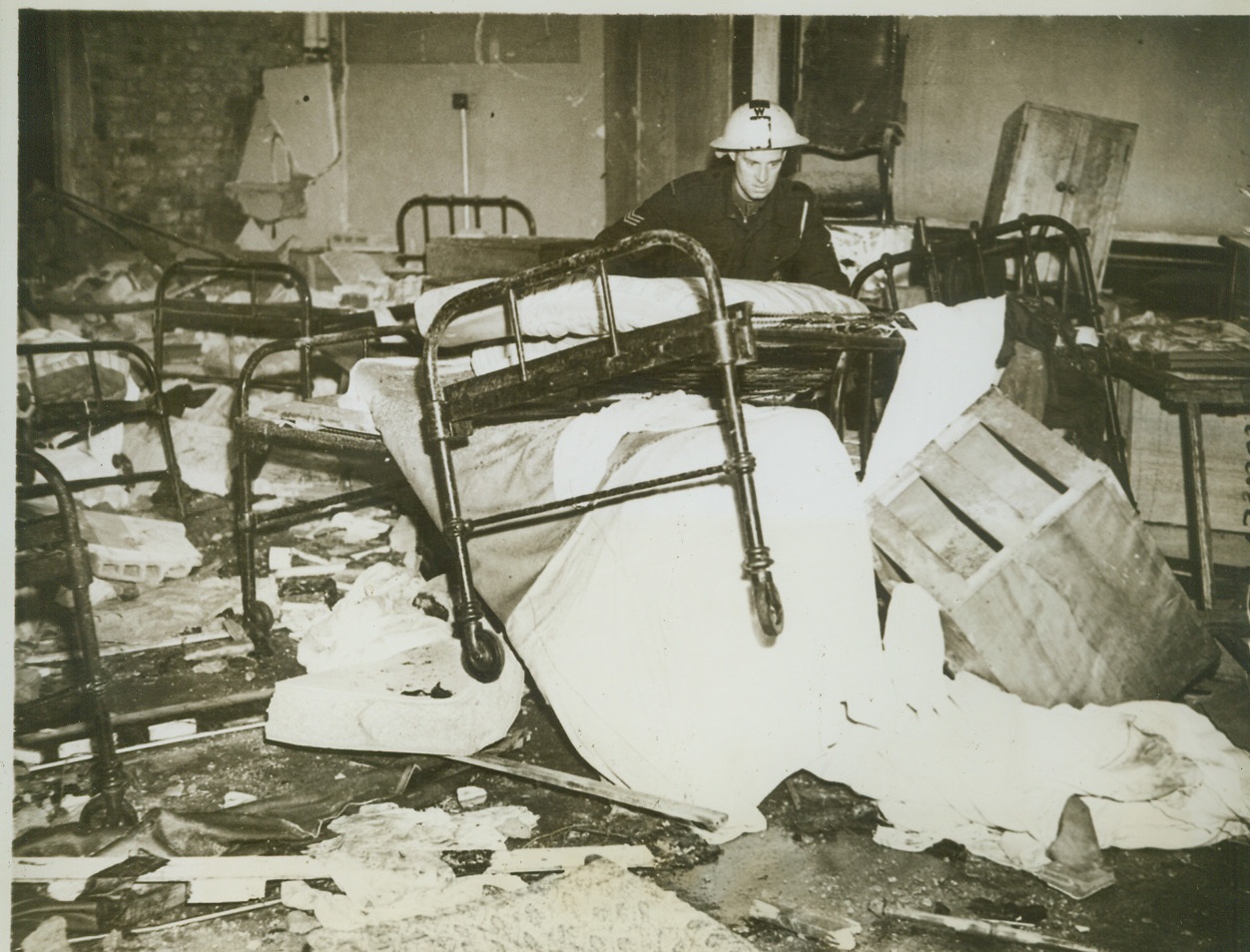 Flying Bomb Strikes Again, 7/14/1944. ENGLAND -- A British soldier looks horror-stricken at the havoc to the ward of a hospital in southern England by one of the Nazi flying bombs. These bombs, a revenge of the Nazis for the Allied invasion of their "Festung Europa", have brought many casualties to the residents of southern England, but Allied planes have been consistently attacking the launching platforms. Credit (ACME);