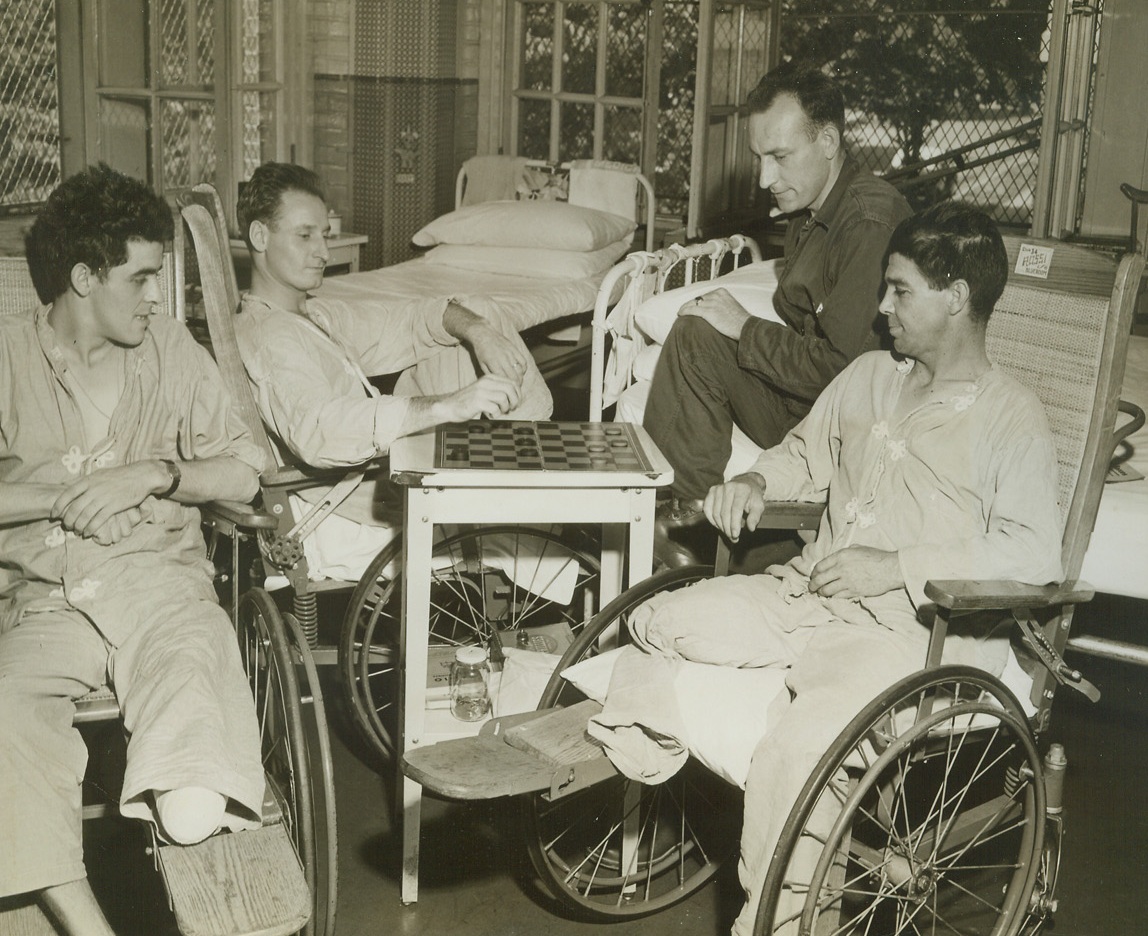 First Normandy Wounded Here, 7/12/1944. Washington, D.C.—Among the first wounded to be brought home from the Normandy beachhead, these four Yank heroes while away the hours with a checkers game, at the Walter Reed Hospital in Washington. Left to right, are: Pfc. James R. Hines, 25, Brookville, Pa.; Pvt. Clarence Osher, 24, Redford, N.Y.; Pfc. Lester A. Walter, 33, Auburn, N.Y.; and Pvt. Lewis E. Morris, 37, Crozet, Va.Credit: ACME.;