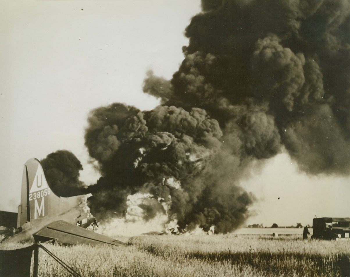 Plane Crashes on Return From Mission, 7/10/1944. A B-17 Flying Fortress of the US 8th Air Force, returning from a mission over Roeun, France, with its brakes shot out, crashed into another B-17 parked near the end of the runway. Fire immediately broke out, engulfing both planes, but the crew miraculously escaped injury.  Credit: Air Force photo from ACME. Radiotelephoto;