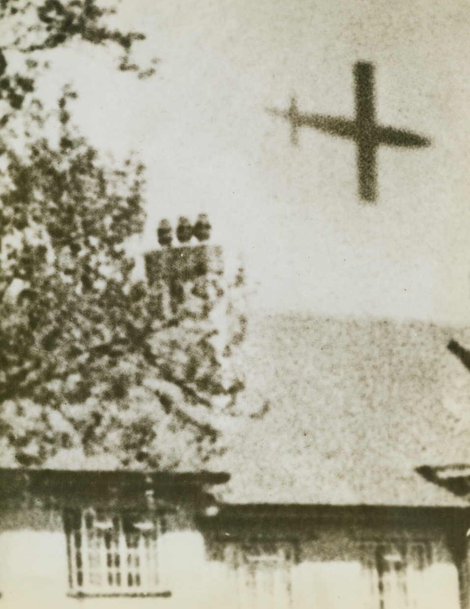 ROBOT HEADS FOR TARGET, 7/18/1944. ENGLAND—A German robot flying bomb about to crash behind a row of small houses in Southern England. Credit Line (ACME);