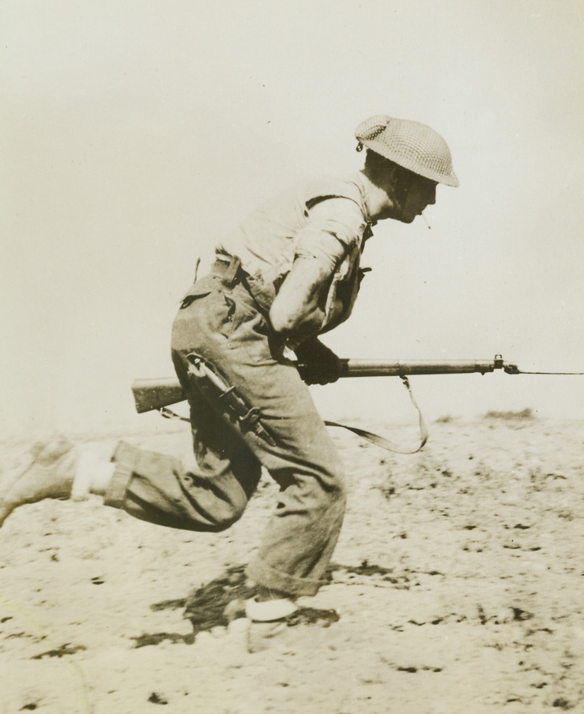 Wounded Canadian Runs To Attack, 7/28/1944. France – Wounded, his arm in a sling, and smoking a cigarette, a Canadian soldier forgets his pain as he dashes ahead to join his comrades in the attack on Colombelle. Taking of the town was part of the assault in which British and Canadian Troops stormed Caen. (Passed by Censor.) Credit: ACME;