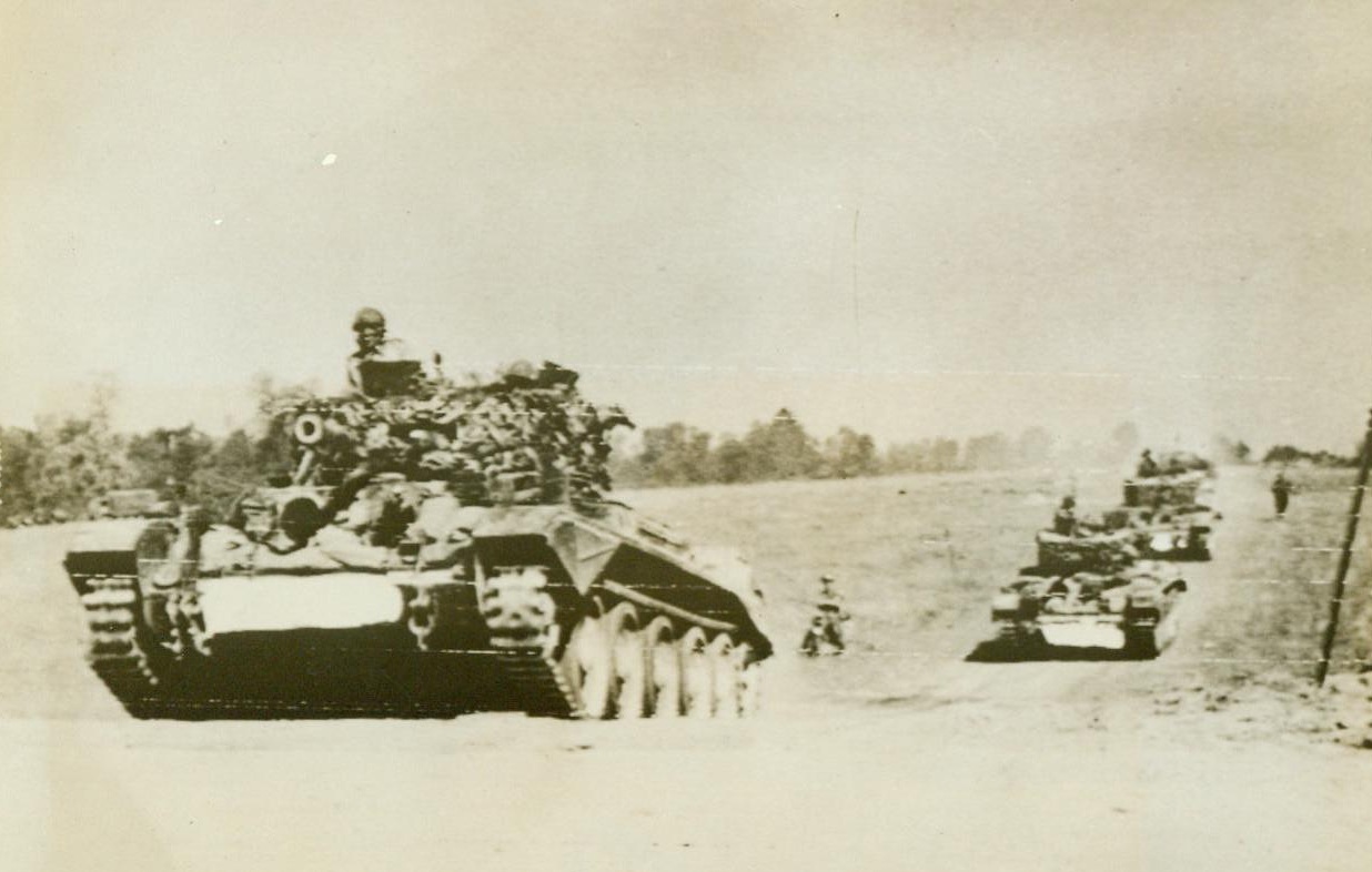 Moving Into Battle Near Caen, 7/19/1944. France -- British tanks move forward across a field during the early stage of the smashing battle between German and Allied armor beyond Caen, July 18th  7/19/44 (ACME);
