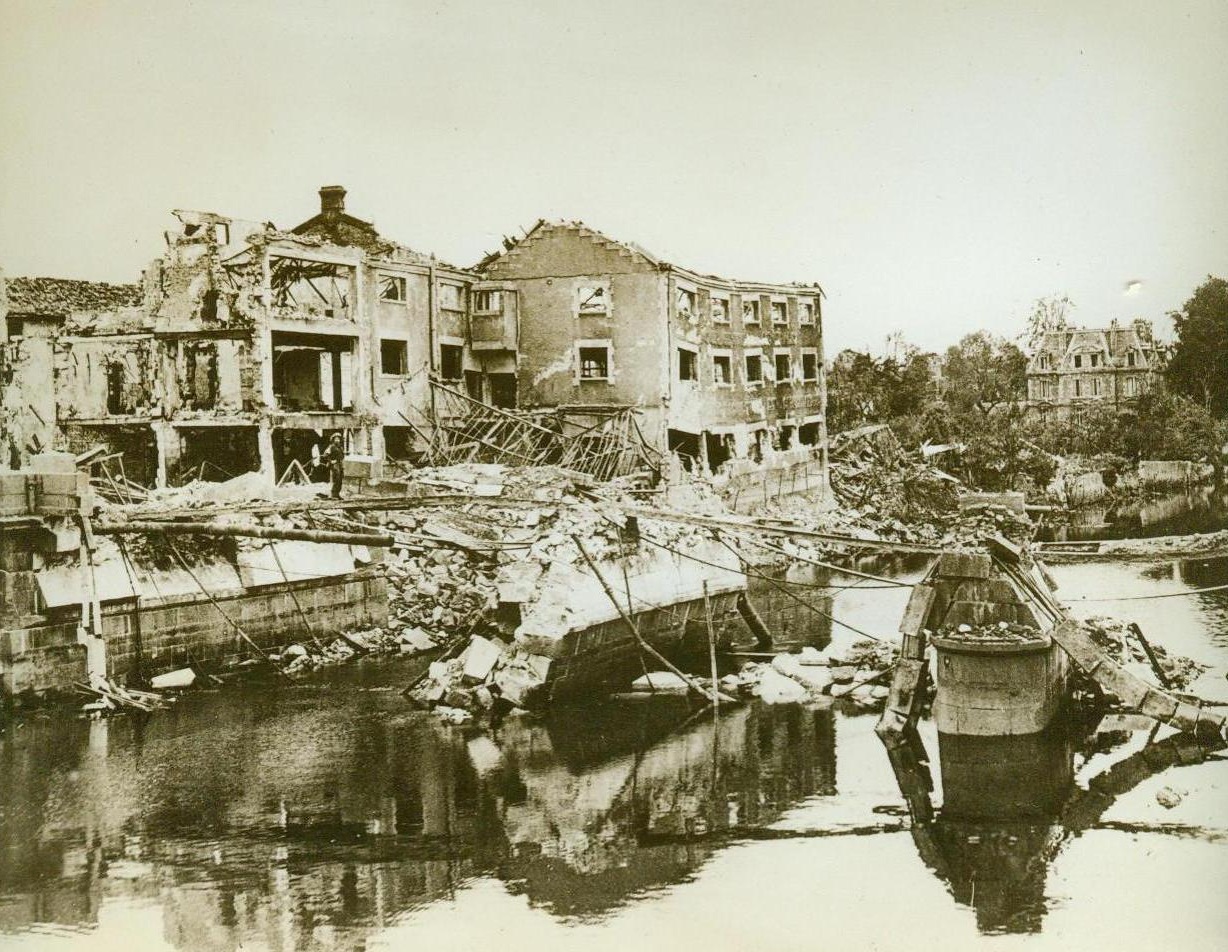 Result Of Allied Bombing, 7/28/1944. France -- Terrific Allied artillery and aerial bombardment preceded the advance by British and Canadian forces past the important city of Caen. The Caen canal to Fauborg remains a mass of twisted steel and rubble after Allied bombers had blasted the area. 7/28/44 (ACME);