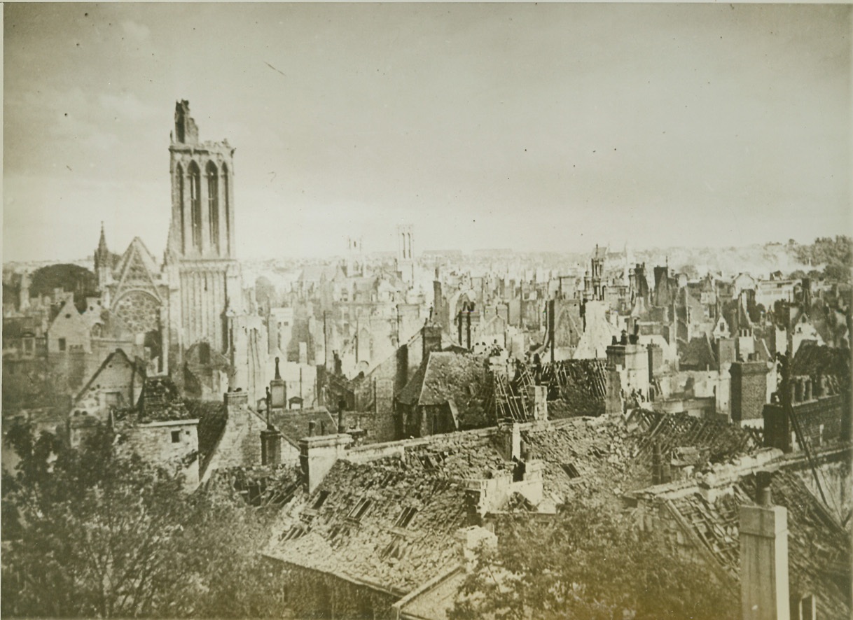 War Struck Here, 7/14/1944. Caen, France—As far as the eye can see, these buildings of Caen have been blasted by shells and bombs or burned as a result of Nazi vandalism. To the left the Cathedral tower, with the top blasted off, stretches bleakly to the sky. This was the sight which greeted British and Canadian troops, entering the city on July 9, on the heels of the retreating Germans. Credit: British official photo from ACME;