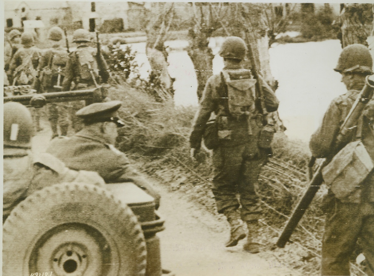 "Ike" Inspects Norman Front, 7/7/1944. France—Riding in the rear of a Jeep, Gen. Dwight D. Eisenhower inspects frontline troops on the march somewhere in France. The supreme commander of Allied expeditionary forces also visited newly won airfield in France and congratulated pilots for the job they were doing in support of ground troops. Credit: U.S. Army radiotelephoto from ACME;