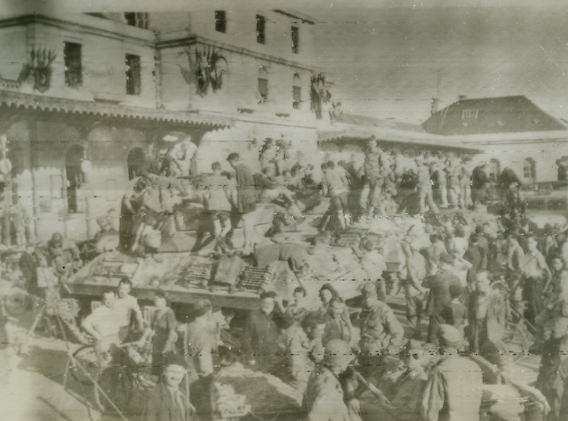 It’s A Great Day for Grenoble, 8/28/1944. GRENOBLE, FRANCE – Swarming from their homes into the street to welcome Americans of the 7th Army who liberated their town, citizens of Grenoble crowd around the armored vehicles in enthusiastic greeting to the Yank forces. Credit (ACME Radiophoto via OWI);