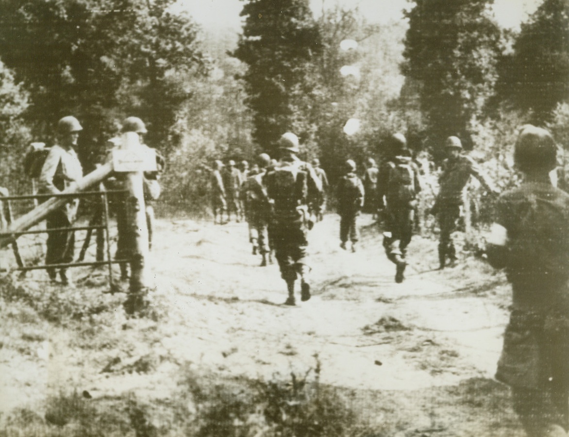 Yanks Skirt Aachen, 8/17/1944. GERMANY – Moving across the border from Belgium, Yanks advance up a road leading to Aachen Staat forest in Germany. American forces have entered the town proper and the Germans are engaging in a desperate house-to-house fight against overwhelming odds. Credit (Signal Corps Radiotelephoto from ACME);