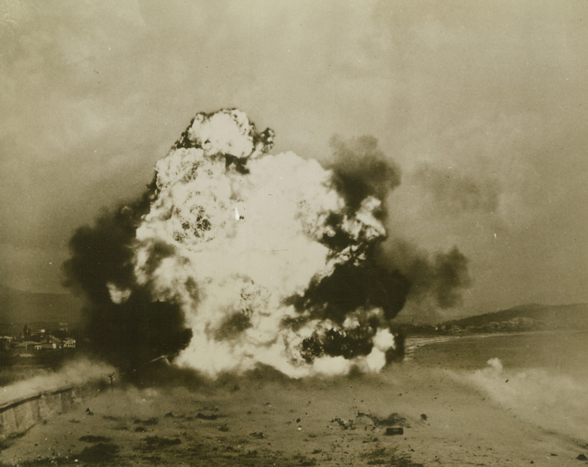 Open Way For Allied Advance, 8/31/1944. France - Blocked by an anti-tank wall, the Allied advance in Southern France was halted - but just fleetingly. Engineers of a demolition squad set to work with teller mines and blasted open a clear path for relentlessly advancing forces. The flash of explosion is seen as the mines go off. St. Raphael is in the background. Credit: Signal Corps photo from ACME;