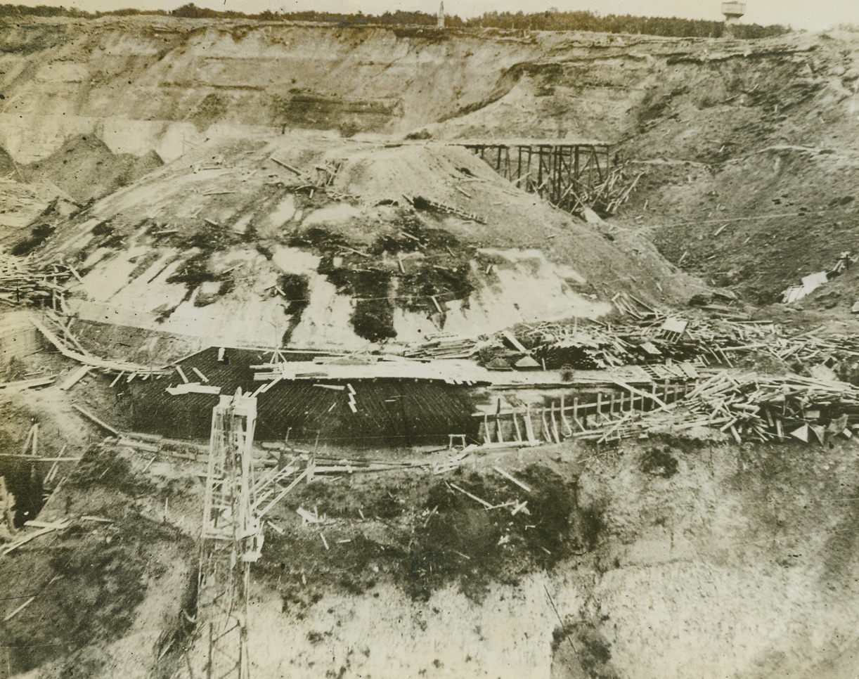 Target For RAF “Heavies”, 8/1/1944. Pas De Calais, France – This concrete dome structure, topping German underground installations in the Pas De Calais area, which are believed to have something to do with the enemy’s threatened use of long-range rockets, was undermined by RAF “heavies” which attacked the area on July 17 and again on July 20. The 12,000-pound bombs tore out a great deal of the cliff supporting the dome, closed up tunnel entrances, and disrupted rail lines. Although this photo was taken before either of these raids, the damaged condition of the area around the dome shows that it had evidently been the target on previous raids. For pictures taken after the RAF July 17 and July 20 attacks, see ACME photo #732304. Credit: British Official Photo from ACME;