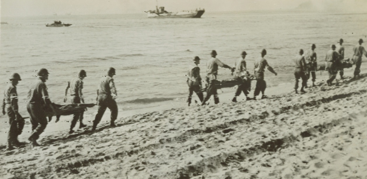 Yank Casualties Leave Southern France, 8/18/1944. France – Litter crews carry American casualties down the coast of Southern France to the waiting Hospital Ships that will evacuate them. These wounded were among the first troops to hit the beach during the initial assault. Credit: Army Radiotelephoto from ACME;