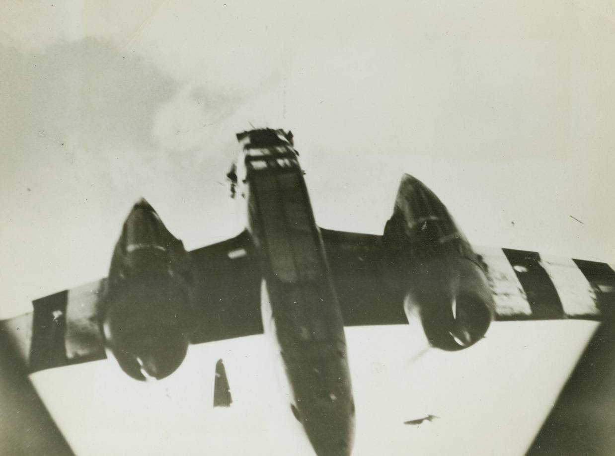 Shot to Pieces, 8/18/1944. The wreckage of the tail section of this A-20 Havoc light bomber of the 9th U.S. Air Force hurtles through the air after the plane was hit by enemy flak somewhere over France. The bomber’s rudder is in an inverted position between the fuselage and the engine at right. The plane plunged to earth just after this photo was made. Credit: USAAF photo from Acme;