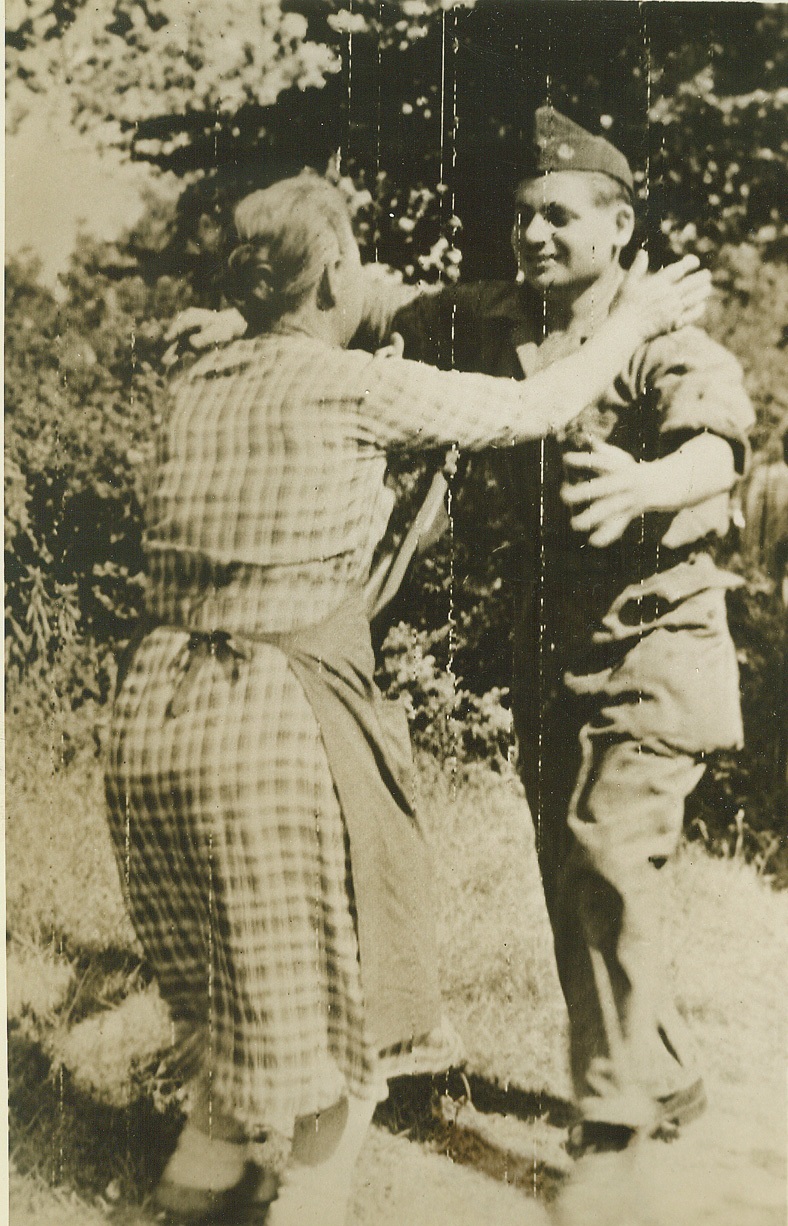 Welcome Home, Son, 8/19/1944. Alencon, France—With her arms outstretched eagerly, a happy mother welcomes her soldier son back to France after the town of Alencon had been freed by advancing American forces. The soldier has returned to his homeland after years of exile while it was under German rule.  Credit: Signal Corps radiotelephoto by ACME;