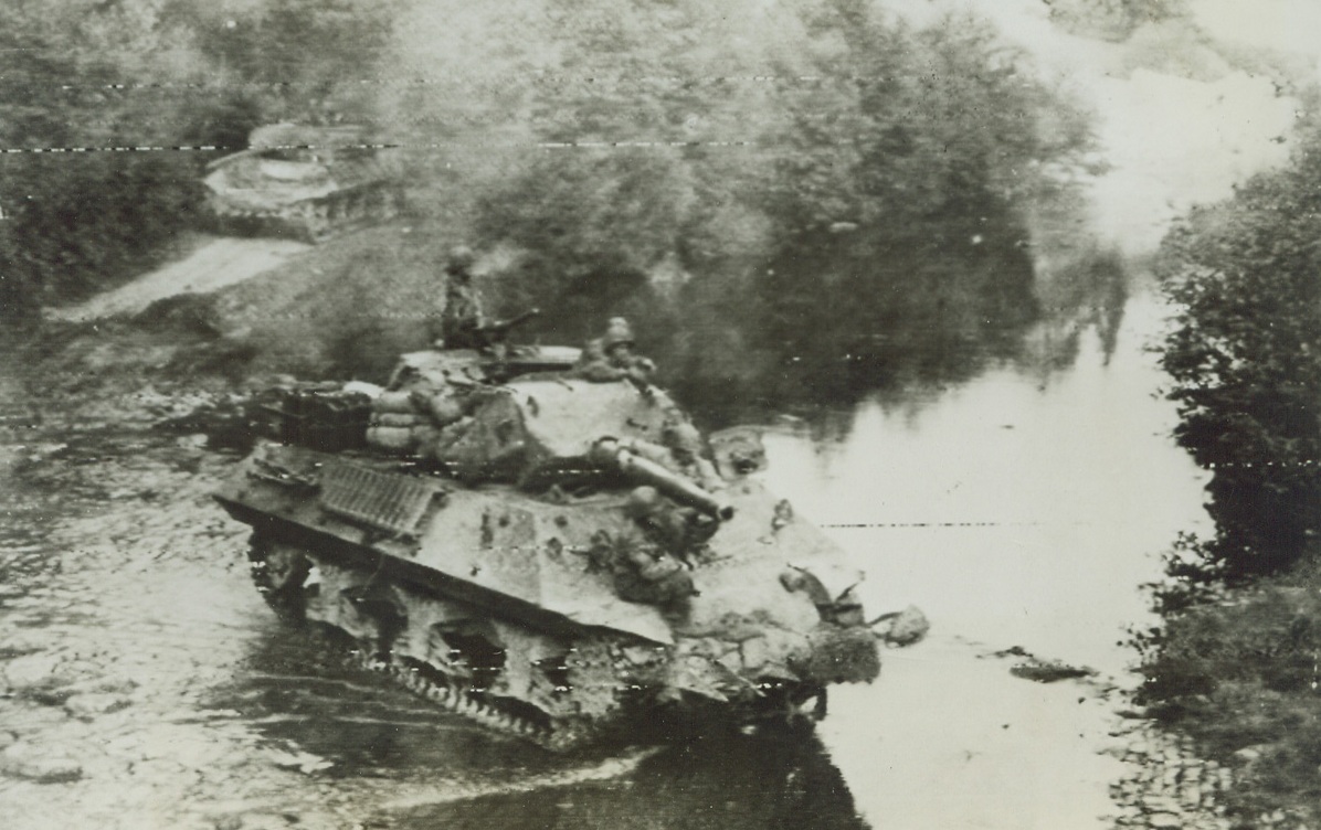 Tank Destroyer Going into Germany, 9/15/1944. An American Tank destroyer crossing a stream marking the German border. In the background to the right is a destroyed German railroad. Credit: SIGNAL CORPS PHOTO VIA RADIOTELEPHOTO.;