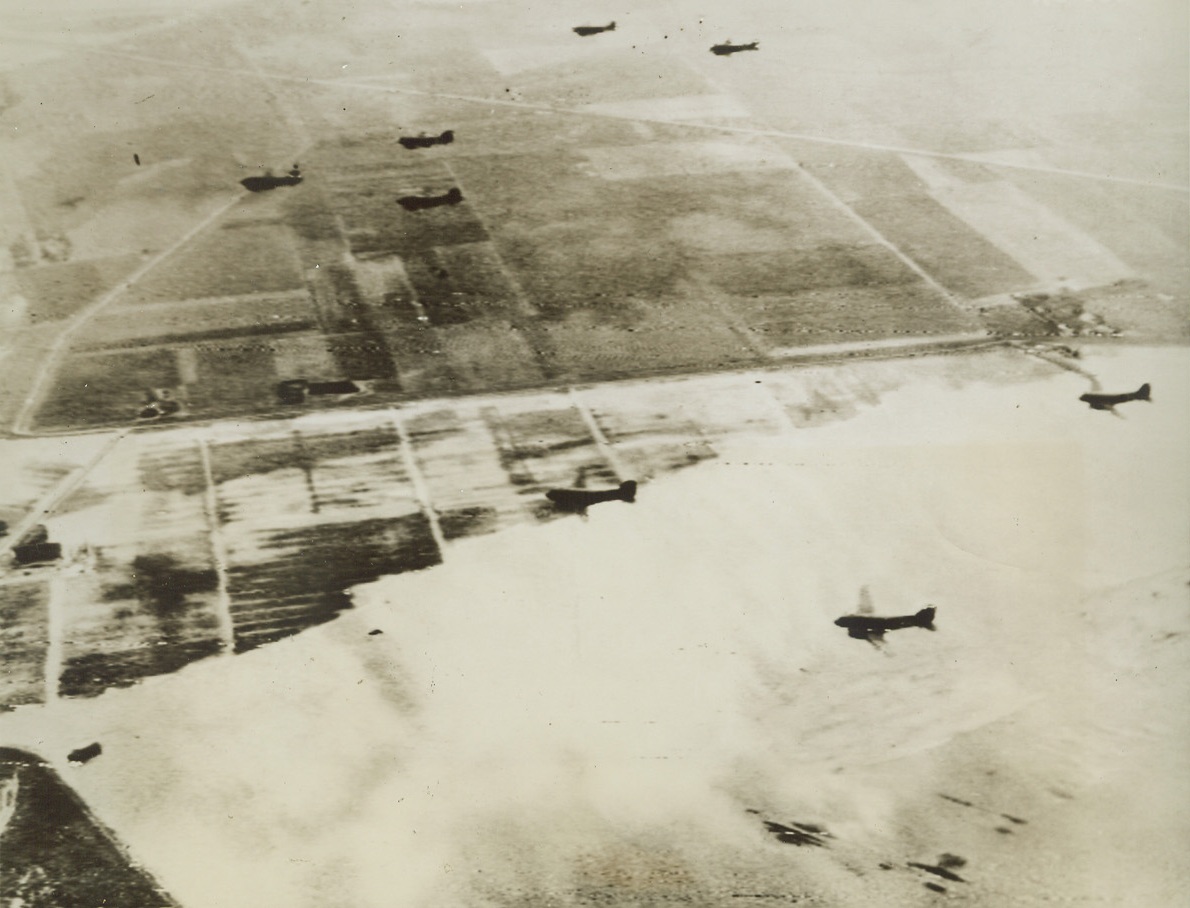Invaders Soar Over Flooded Lowlands, 9/18/1944. HOLLAND – With flood waters lapping across the Holland countryside below, a train of C-47 transports carries a paratroop cargo to its invasion destination. A giant armada of warrior-carrying planes participated in the sky-borne invasion, landing, according to German reports, at Nijmegen, Tilburg and Eindhoven. Credit (Signal Corps Radiotelephoto from ACME);