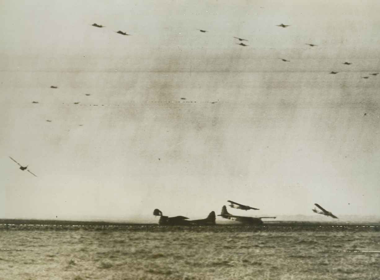 Allied Gliders Land in Holland, 9/21/1944. Loaded with American troops and equipment, gliders swoop down to a landing behind the German lines in Holland. Other craft with their tow planes soar overhead. Credit Line (Army Radiotelephoto from ACME);