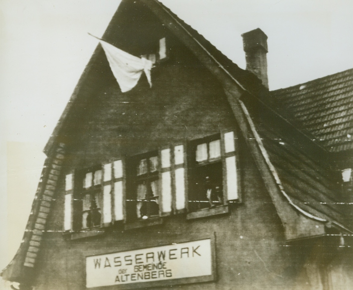 Symbols of Surrender Greet Yanks in Germany, 9/17/1944. AACHEN, GERMANY – The white flag of surrender flies from a gable window in this house near Aachen, Germany. Yanks nearing Aachen were greeted by frequent sights like this. Reports indicated that the Germans’ initial cold attitude toward the Americans has warmed somewhat when they discovered that the invaders weren’t the terrors the Nazi officials would have them be. Credit (Signal Corps Radiotelephoto from ACME);