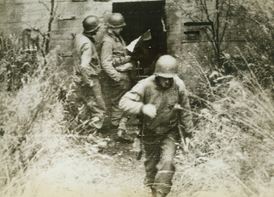 Temporary Quarters, 9/17/1944. GERMANY – Yank infantrymen stand in the doorway of an abandoned pillbox inside the German border. Reaching the post shortly after the Nazis fled, American troops established temporary headquarters here. Credit (Signal Corps Radiotelephoto from ACME);