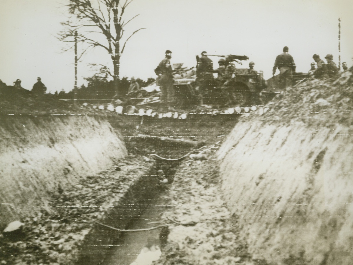 Tank Trap no Obstacle for Yank Jeep, 9/16/1944. GERMANY – Over an improvised bridge, rigged up by Yank engineers as soon as the area was cleared of Nazis, an American Jeep crosses a 15-foot tank trap which was part of the vaunted Siegfried Line. Credit – WP –(Army Radiotelephoto from ACME);