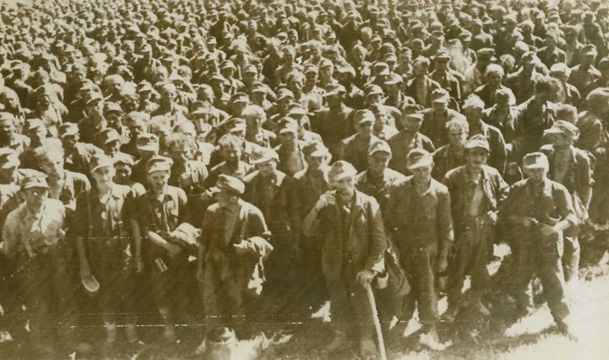 Round-up in Romania, 9/10/1944. ROMANIA—A horde of German prisoners, part of the thousands captured as the Russian Balkan drive engulfed Romania, stand with mess kits in hand waiting for chow at an unidentified locale in Romania.Credit (Acme Radiophoto);