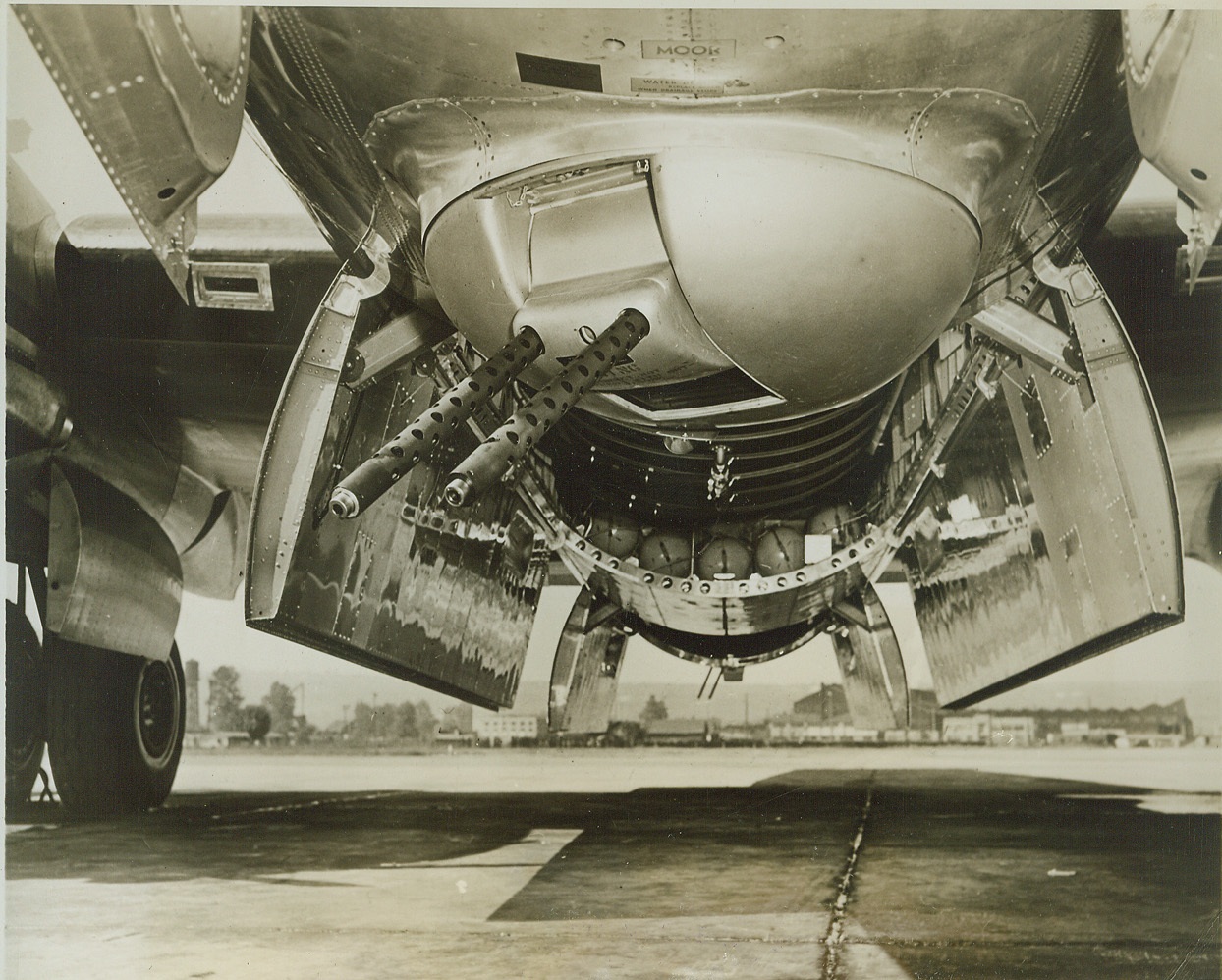 Superfortress Carries Five Gun Turrets, 9/8/1944. For the first time, the gun positions on the Boeing Superfortress are revealed. Five turrets, each with two .50 caliber guns, are placed at strategic positions on the bomber. Here the forward lower turret can be seen, with the two guns, on the under side of the fuselage beneath the pilot's cabin. The bomb bay doors are open. In addition to these guns, the tail turret also mounts a 20mm cannon. All turrets are remotely controlled which makes possible the operation of all guns by gunners in different parts of the bomber. Credit (ACME);