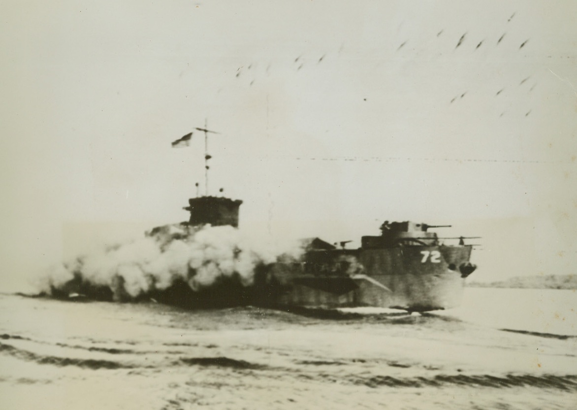 Rocket Fire Heralds Invasion of Morotai, 9/19/1944. Morotai, Halmahera Is. – As smoke forms a screen for its maneuvers this assault landing craft of the US Fleet pours a stream of rocket fire up on the beach at Morotai, as American Forces land their first wave of invaders. Mopping up operations are now in progress on Morotai, stepping stone to the Philippines. Credit: Signal Corps Radiotelephoto from ACME;