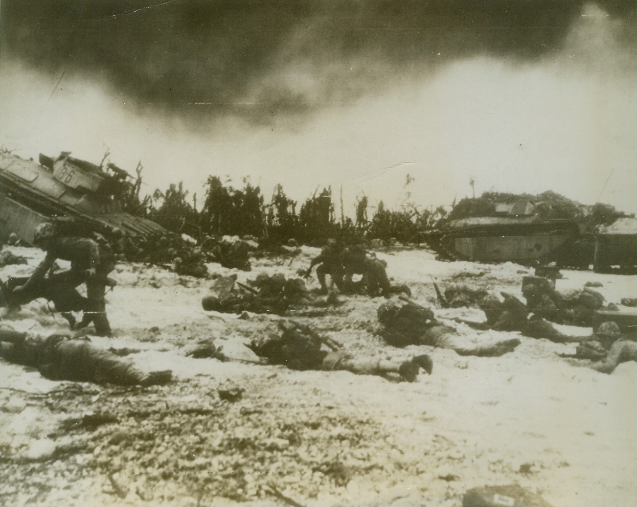 Marines Swarm Ashore on Peleliu Island, 9/20/1944. Peleliu Island – Assault troops of First Marine division hit Peleliu island beach – some never to rise again – as the established beachhead in Paulaus in toughest fighting of three invasions flanking Philippines.  Jap defenders fought grimly in retreat under pressure from ceaseless land, sea and air attack.  Photo radioed from Honolulu to San Francisco. Credit line (ACME);