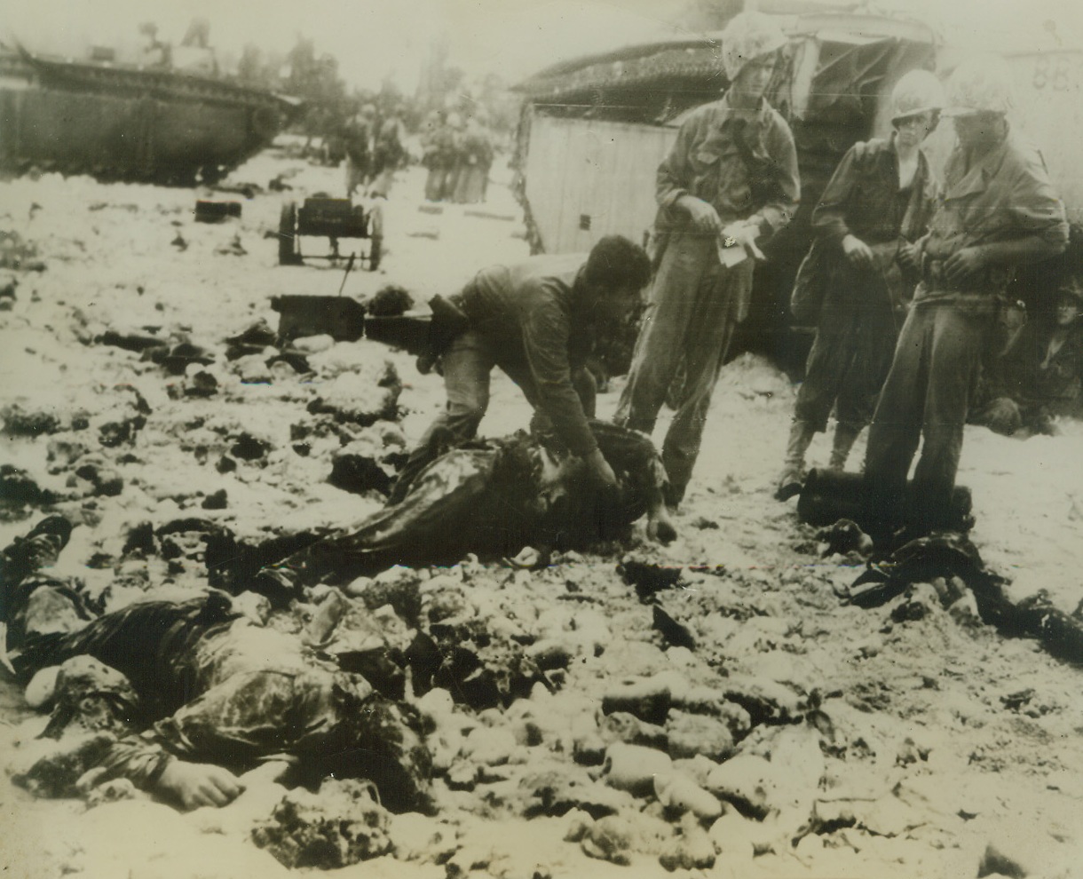 Invasion Toll, 9/10/1944. Peleliu Island – The price of conquest is never cheap.  These two Leathernecks of First Marine division lie where they fell in beach of Peleliu island in Palaus where they landed with first wave of assault troops storming the strategic island carrier to the Philippines.  Photo radioed from Honolulu to San Francisco. Credit line (ACME);