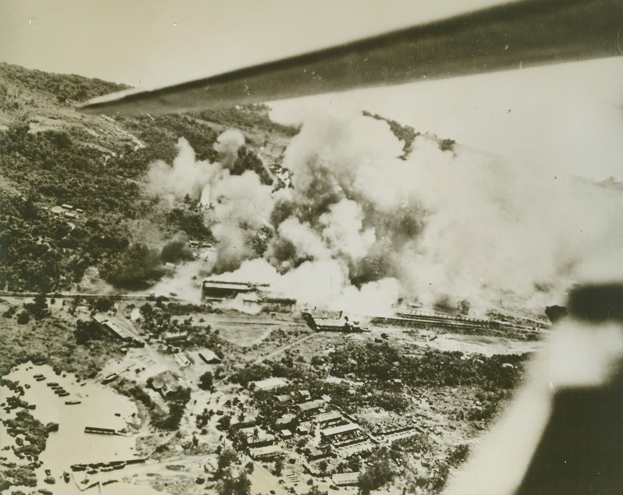 Prelude to Palau Landings, 9/15/1944. In a smashing prelude to the landings which took place yesterday, Navy planes from Adm. William F. Halsey’s third fleet struck Jap-held Palau repeatedly on July 26-27.  Smoke rises from the blasted installations during the continued aerial hammering. Credit (U.S. Navy photo from ACME);