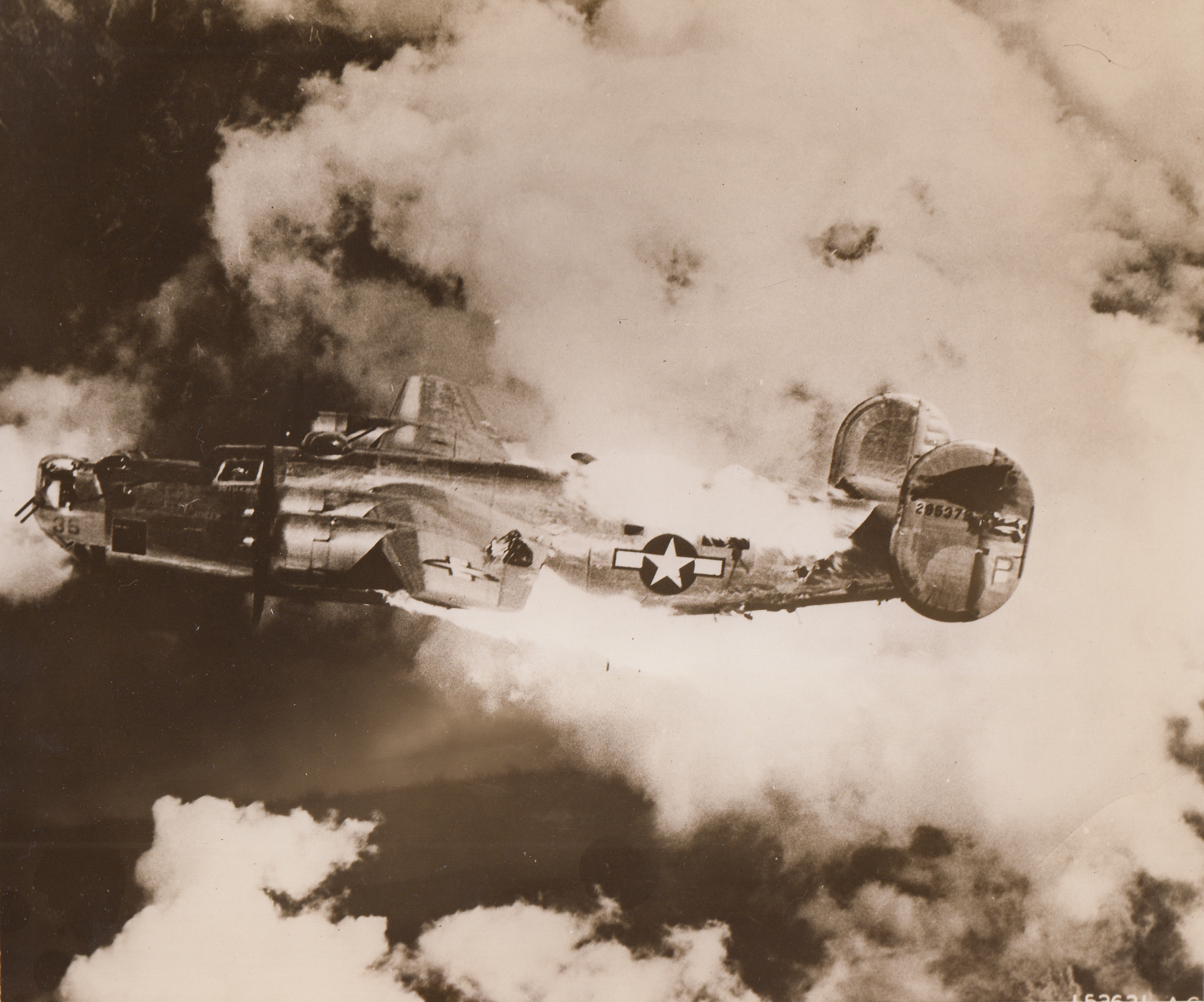 A Liberator on its Last Mission, 9/8/1944. Flames roar from the fuselage of a mortally wounded Liberator from Austria. Seconds later the big ship plummeted to earth. Photographer said the pilot was still in the cockpit, gunner in the tail.;