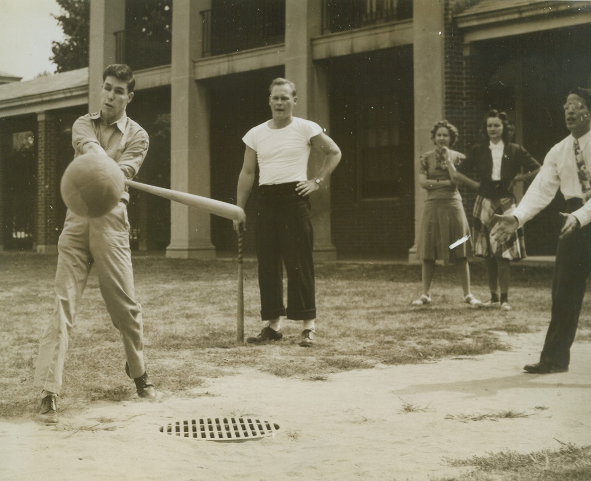 Sightless Marines Play Baseball With Blind, 9/8/1944. New York—Pfc. John G. Corrie, who lost his sight landing with the first parachute battalion of Marines behind the Jap lines at Bougainville, hits the ball in game yesterday at the New York Institute for the Education of the Blind, 999 Pelham Parkway, the Bronx. Another blind student prepares to catch the ball in case Corrie misses. Standing by is Henry R. Linville, pharmacist’s mate 3/o, who is in charge of the six Marines at the school.Credit: ACME.;